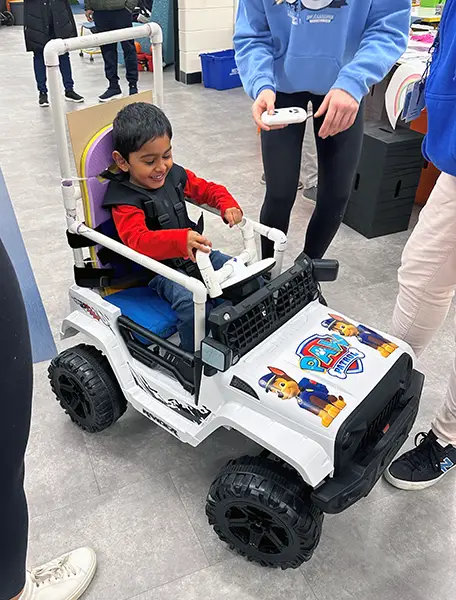 A young boy enjoying his GoBabyGo car