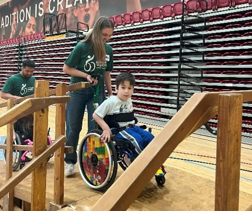 A young boy learning wheelchair skills