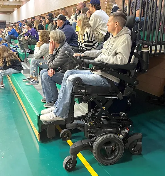 Lonnie getting a better view of a game with his seat elevated