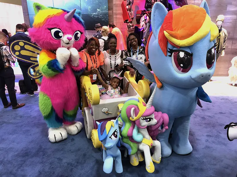 A young girl in her wheelchair costume with her family