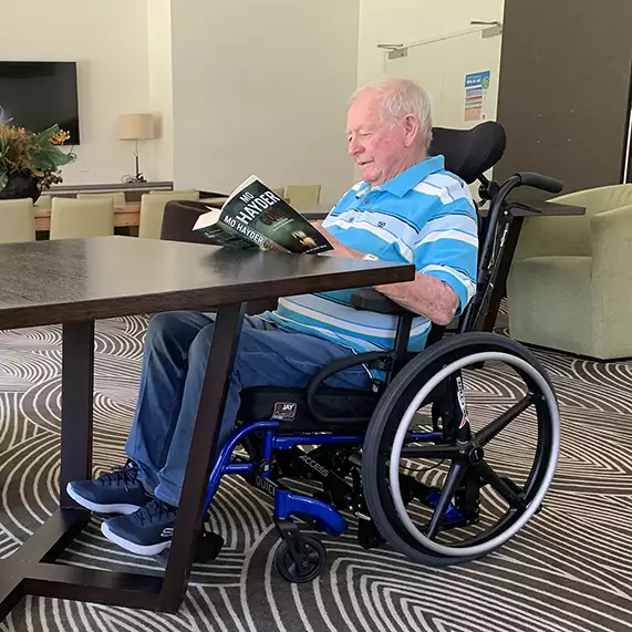 Photo of a man in a QUICKIE Access fitting under a table