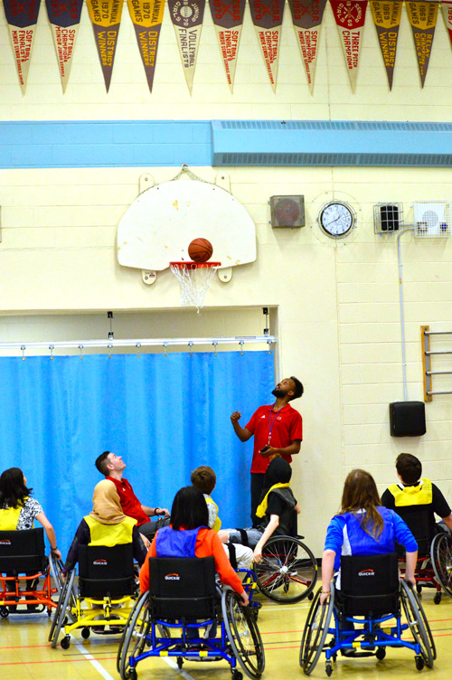 School children playing wheelchair basketball