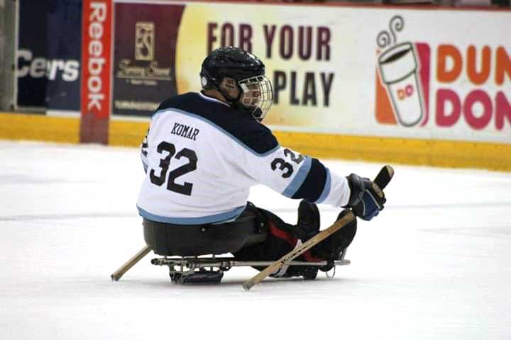 Eric playing sled hockey