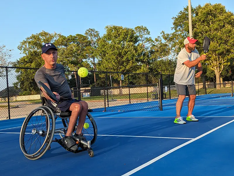 Two men playing pickleball