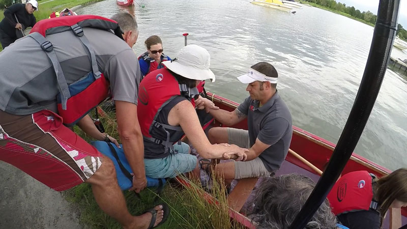 Dragon boat paddler transferring into the boat