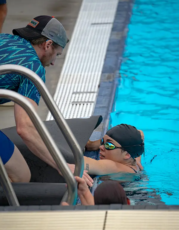 Eden Schroeder speaking with her coach