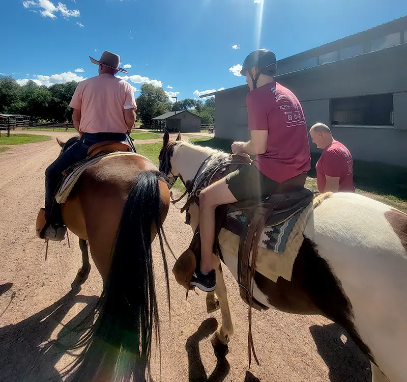 Campers riding horses