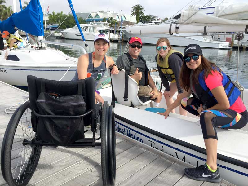 Physical therapy students with a disabled sailor