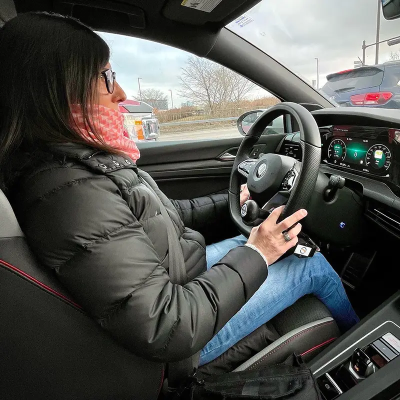 Geneviève driving her adapted Volkswagen GTI