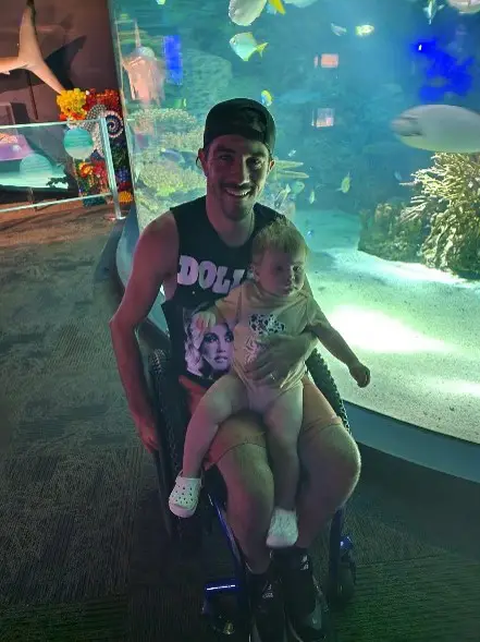 Zac and his child at the aquarium