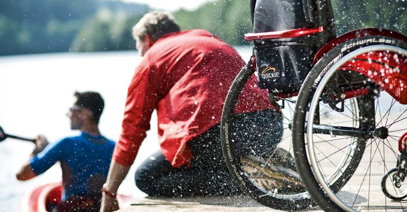 People with disabilities having fun on a lake